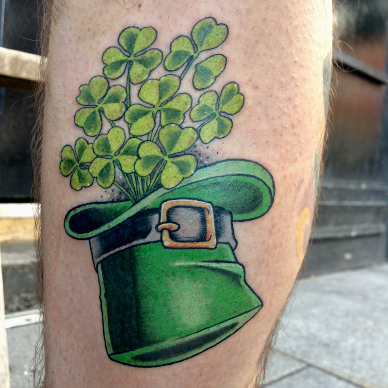 Minimalistic style clover tattooed on the shoulder.